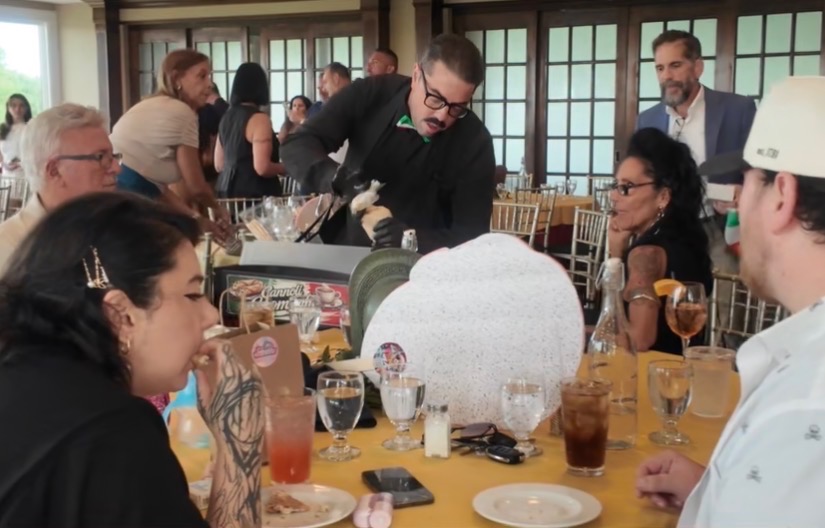 Philip serving fresh cannoli to guests at a formal event
